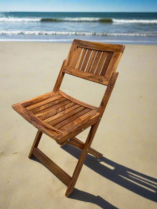 Wooden folding chair on a tiled floor with a plain wall background